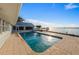 Waterfront in-ground pool with brick pavers, view of dock, and scenic ocean views at 336 S Orchid Dr, Ellenton, FL 34222
