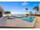 Waterfront in-ground pool and hot tub with brick pavers and lounge chairs overlooking the water at 336 S Orchid Dr, Ellenton, FL 34222