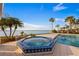 Inviting pool and spa area with comfortable lounge chairs offering stunning waterfront views and tropical landscaping at 336 S Orchid Dr, Ellenton, FL 34222