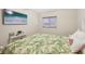Cozy bedroom with a decorative bedspread, a window, and a wall-mounted television at 3419 31St E St, Bradenton, FL 34208