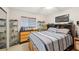 Neutral bedroom with a striped bedspread, dresser and personal collections on display at 3419 31St E St, Bradenton, FL 34208