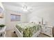 Cozy bedroom with a white bed frame, ceiling fan, and a window with natural light at 3419 31St E St, Bradenton, FL 34208