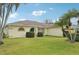 Charming single-story home with a well-manicured lawn, tropical landscaping, and a welcoming teal-colored front door at 3419 31St E St, Bradenton, FL 34208