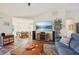 Comfortable living room with view to dining area, modern entertainment center, and hardwood floors at 3419 31St E St, Bradenton, FL 34208