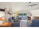 Inviting living room with comfortable seating, ceiling fan, and a view of the serene outdoor scenery at 3419 31St E St, Bradenton, FL 34208