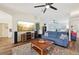 Bright living room featuring hardwood floors, modern entertainment center, and large windows at 3419 31St E St, Bradenton, FL 34208