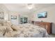 Comfortable main bedroom with a view of the patio, lake and a mounted television at 3419 31St E St, Bradenton, FL 34208