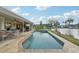 Inviting pool and patio area overlooking a serene lake, perfect for relaxing and entertaining outdoors at 3419 31St E St, Bradenton, FL 34208
