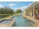 Relaxing pool and spa with colorful chairs and a picturesque view of the tranquil lake at 3419 31St E St, Bradenton, FL 34208