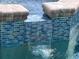 An eye-level close-up shot showcasing the sparkling, tiled waterfall feature of the pool at 3419 31St E St, Bradenton, FL 34208