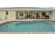 View of the pool with a tiled patio and covered outdoor seating area at 3419 31St E St, Bradenton, FL 34208