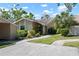 Home featuring manicured lawn, sidewalk, and shade trees at 3461 Tallywood Cir # 7067, Sarasota, FL 34237