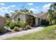 Charming home showcasing lush landscaping, a well-manicured lawn, and a welcoming walkway at 3461 Tallywood Cir # 7067, Sarasota, FL 34237