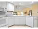 Well-lit kitchen with stainless steel appliances, ample counter space, and bright lighting at 3461 Tallywood Cir # 7067, Sarasota, FL 34237