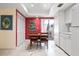 Bright kitchen with white cabinets, a dining table, and a sliding door to the outside at 3461 Tallywood Cir # 7067, Sarasota, FL 34237