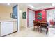 Kitchen view with a dishwasher, dining area, outdoor access, and colorful wall accents at 3461 Tallywood Cir # 7067, Sarasota, FL 34237