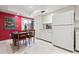 Bright kitchen featuring all-white appliances, marble tile flooring, and a dining table with chairs at 3461 Tallywood Cir # 7067, Sarasota, FL 34237
