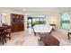 Bright living room featuring marble floors, a large window, and sliding glass doors to the lanai at 3461 Tallywood Cir # 7067, Sarasota, FL 34237