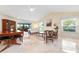 Spacious living room with a vaulted ceiling, tile floors, and a sunroom view at 3461 Tallywood Cir # 7067, Sarasota, FL 34237