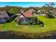 Aerial view of a lakeside property with a screened pool and well-manicured lawn at 3712 59Th Avenue E Cir, Ellenton, FL 34222