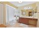 Spacious bathroom with a long vanity, shower-tub combo, and tile flooring at 3712 59Th Avenue E Cir, Ellenton, FL 34222