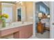 Bathroom with double sinks, mirror and a bedroom view at 3712 59Th Avenue E Cir, Ellenton, FL 34222
