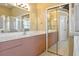 Bright bathroom featuring a double vanity, glass shower, and large mirror at 3712 59Th Avenue E Cir, Ellenton, FL 34222