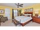 Cozy bedroom with plantation shutters, ceiling fan, and natural light at 3712 59Th Avenue E Cir, Ellenton, FL 34222