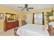 Bedroom with natural light, ceiling fan, and dark wood furniture at 3712 59Th Avenue E Cir, Ellenton, FL 34222