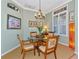 Cozy dining room featuring a round glass table with four chairs, shuttered windows, and classic decor at 3712 59Th Avenue E Cir, Ellenton, FL 34222