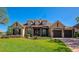 Charming single-Gathering home featuring a manicured lawn, stone accents, dormer windows and a brick-paved driveway at 3712 59Th Avenue E Cir, Ellenton, FL 34222