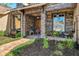 Close-up of the front porch with stone accents, a brick walkway, plants and cozy furniture at 3712 59Th Avenue E Cir, Ellenton, FL 34222