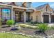 Inviting home entrance with stone accents, a brick walkway, lush landscaping, and a cozy seating area at 3712 59Th Avenue E Cir, Ellenton, FL 34222