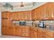 Kitchen featuring stainless steel appliances, wood cabinets, and granite countertops at 3712 59Th Avenue E Cir, Ellenton, FL 34222