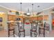 A kitchen with wood cabinets, granite countertops, and an island with barstool seating at 3712 59Th Avenue E Cir, Ellenton, FL 34222