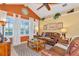 Cozy living room with vaulted ceilings, a large window, and comfortable leather seating at 3712 59Th Avenue E Cir, Ellenton, FL 34222