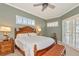 Main bedroom with shuttered windows, decorative furnishings, and ensuite access at 3712 59Th Avenue E Cir, Ellenton, FL 34222