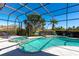 Screened-in pool and spa with a lush landscape and serene lake views, creating a private oasis at 3712 59Th Avenue E Cir, Ellenton, FL 34222