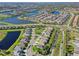 Gorgeous aerial view of a planned community, with lush green spaces and beautiful ponds at 3835 Autumn Fern Ter, Sarasota, FL 34243