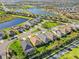 An aerial view of a residential area with well-maintained homes, green spaces, and scenic lakes at 3835 Autumn Fern Ter, Sarasota, FL 34243