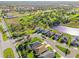An aerial view of houses in a neighborhood with a lake and green areas at 3835 Autumn Fern Ter, Sarasota, FL 34243