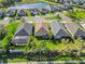 Aerial view of home backing up to green space in a neighborhood with a lake at 3835 Autumn Fern Ter, Sarasota, FL 34243
