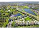 A stunning aerial view showcases a well-maintained residential community with scenic ponds and lush green spaces at 3835 Autumn Fern Ter, Sarasota, FL 34243