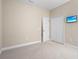 Comfortable bedroom with a closet, neutral walls, carpet flooring, and a mounted television for entertainment at 3835 Autumn Fern Ter, Sarasota, FL 34243