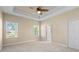 A comfortable bedroom with a ceiling fan, neutral paint, and plenty of natural light, perfect for relaxation at 3835 Autumn Fern Ter, Sarasota, FL 34243