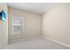 Well-lit bedroom features neutral walls, carpet flooring, and window with blinds providing natural light at 3835 Autumn Fern Ter, Sarasota, FL 34243