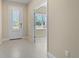 Bright foyer featuring tile flooring, white trim, and a door with sidelight at 3835 Autumn Fern Ter, Sarasota, FL 34243