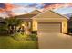 Charming single-story home boasts a well-manicured lawn and a two-car garage at 3835 Autumn Fern Ter, Sarasota, FL 34243