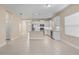 An open kitchen features white cabinets, stainless steel appliances, and granite countertops with a breakfast bar at 3835 Autumn Fern Ter, Sarasota, FL 34243