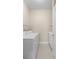 Functional laundry room with a washing machine, dryer, sink, and storage shelves for convenience at 3835 Autumn Fern Ter, Sarasota, FL 34243